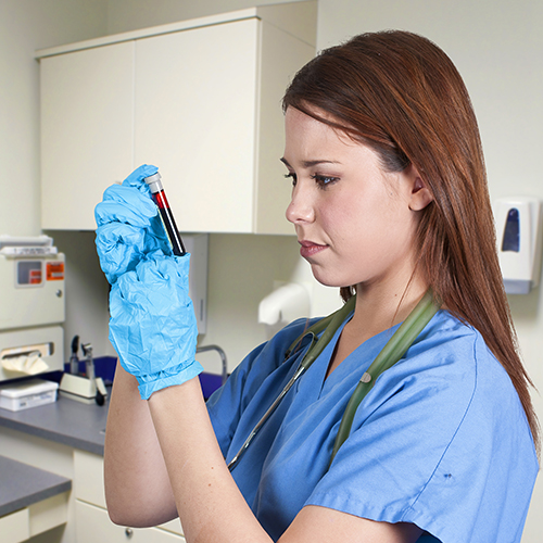 Phlebotomy Aide handling patient's blood sample