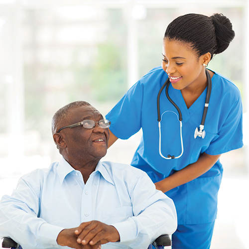 Nurse taking care of senior patient in wheelchair